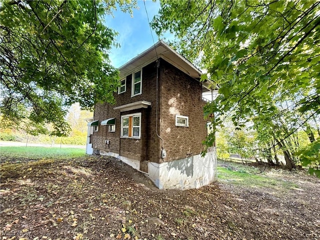 view of home's exterior with brick siding