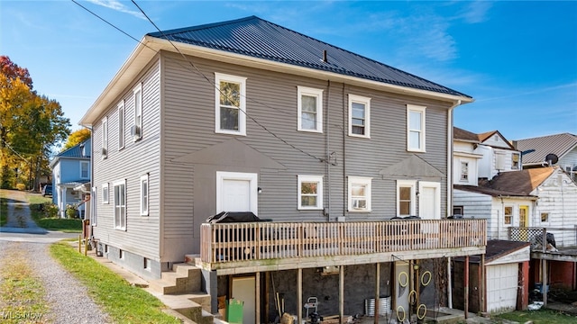 rear view of house featuring a wooden deck