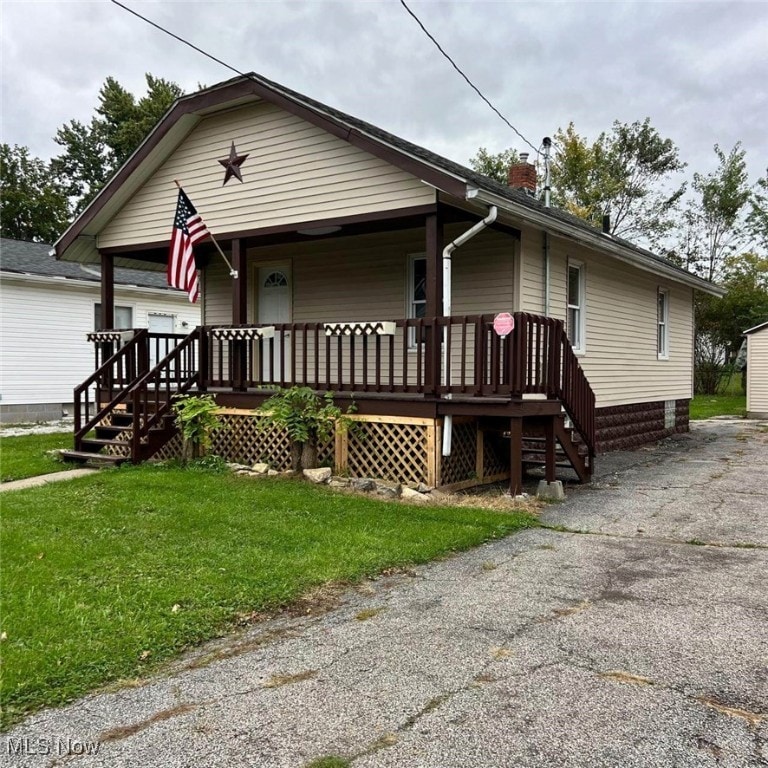 bungalow-style house featuring a porch and a front yard