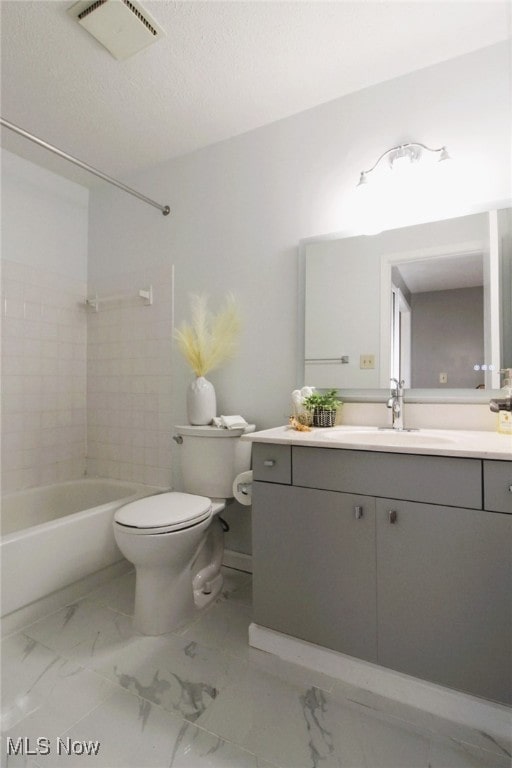 full bathroom featuring vanity, tiled shower / bath combo, and toilet