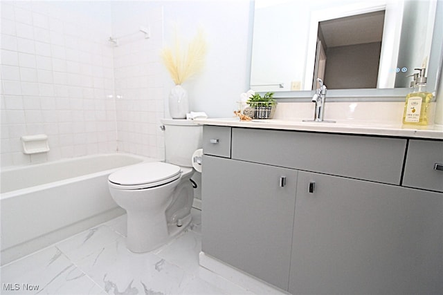 full bathroom featuring tiled shower / bath, vanity, and toilet