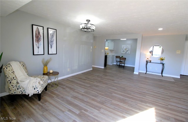 unfurnished room with light hardwood / wood-style floors and a chandelier