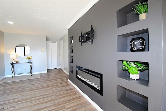 foyer entrance featuring crown molding and hardwood / wood-style flooring