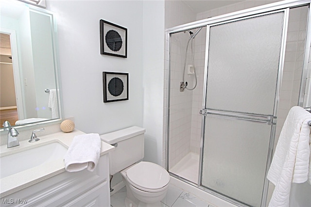 bathroom featuring vanity, toilet, and walk in shower