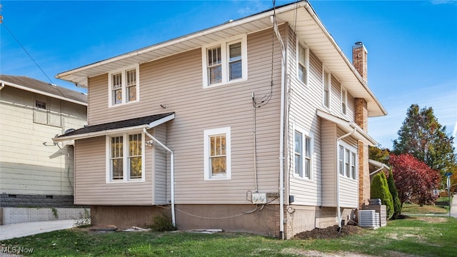 rear view of property featuring cooling unit