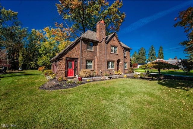 rear view of house featuring a lawn