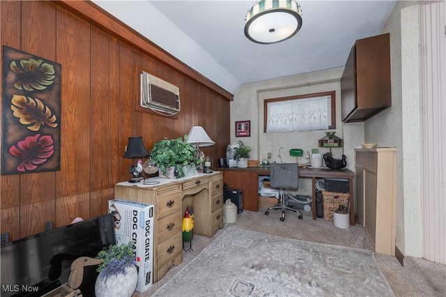 carpeted office featuring a wall mounted AC, wooden walls, and lofted ceiling