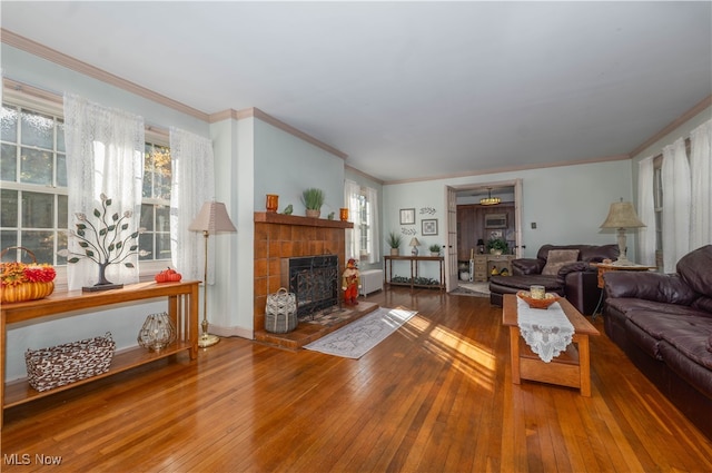 living room with crown molding, hardwood / wood-style floors, and ceiling fan