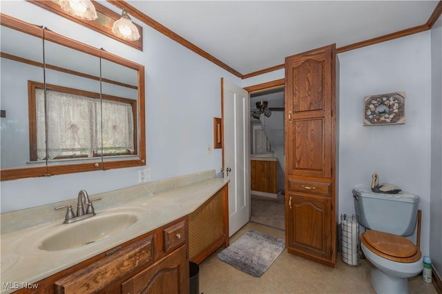 bathroom featuring vanity, toilet, and ornamental molding