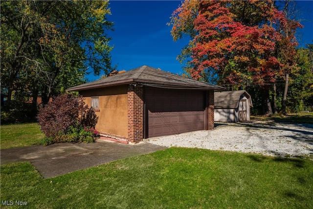 view of property exterior with a garage, a yard, and a shed