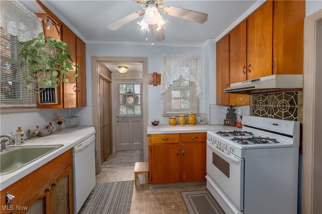 kitchen with crown molding, ceiling fan, sink, white appliances, and decorative backsplash