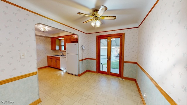 interior space featuring french doors, ceiling fan, and sink