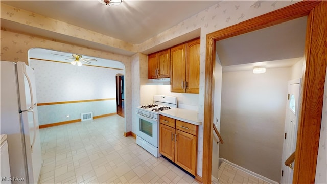 kitchen featuring ceiling fan and white appliances