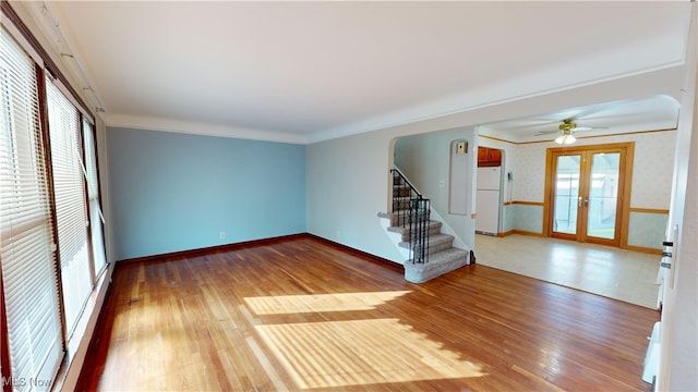 unfurnished room featuring ornamental molding, french doors, hardwood / wood-style flooring, and ceiling fan