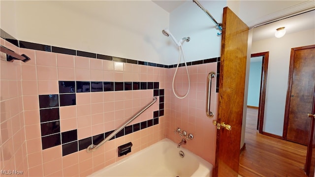 bathroom featuring tiled shower / bath and wood-type flooring