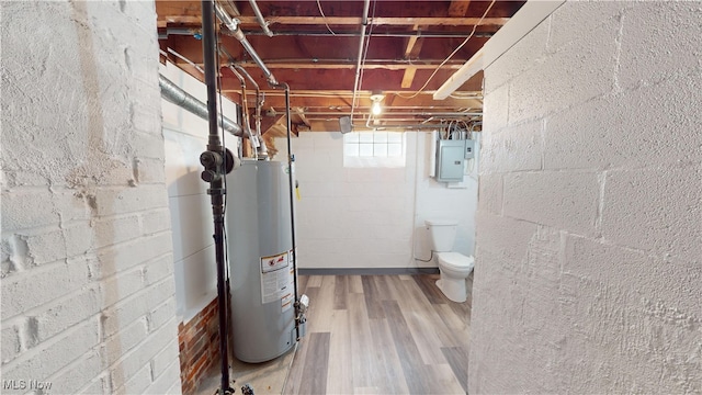 basement featuring water heater, electric panel, and hardwood / wood-style floors