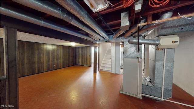 basement featuring wood walls