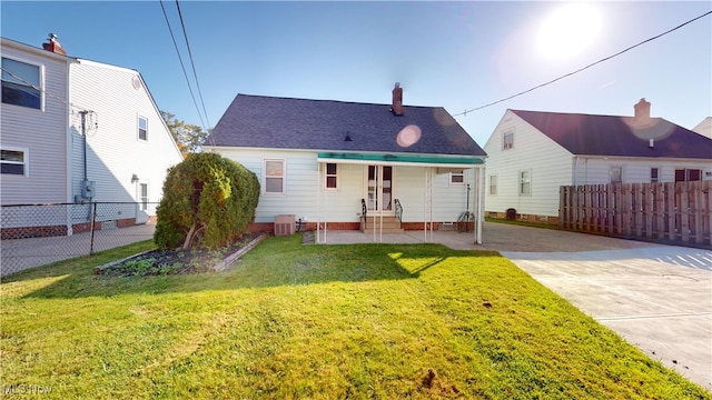 back of property featuring a yard, a patio area, and cooling unit