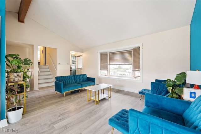 living room with beam ceiling, high vaulted ceiling, and light hardwood / wood-style flooring