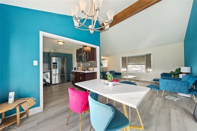 dining area featuring light hardwood / wood-style floors and an inviting chandelier