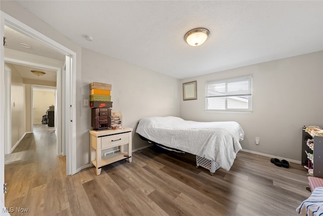 bedroom with hardwood / wood-style flooring