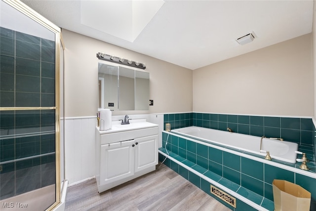 bathroom featuring vanity, hardwood / wood-style flooring, and independent shower and bath