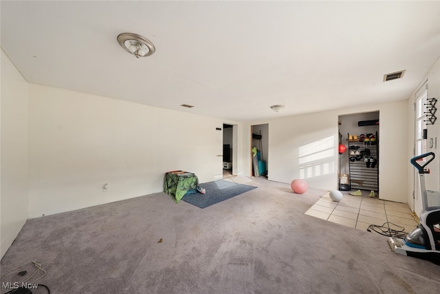 exercise area featuring light colored carpet