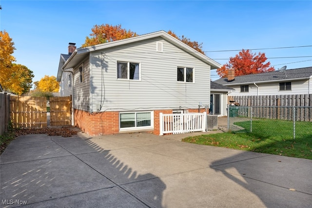 rear view of property featuring a yard and a patio area