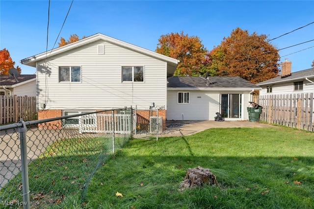 back of house featuring a yard and a patio area