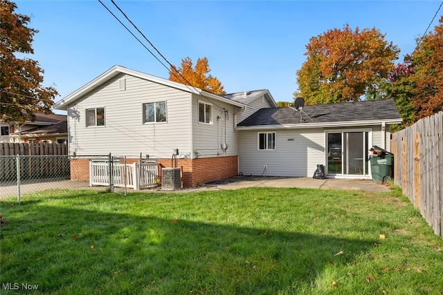 back of property with a patio and a yard