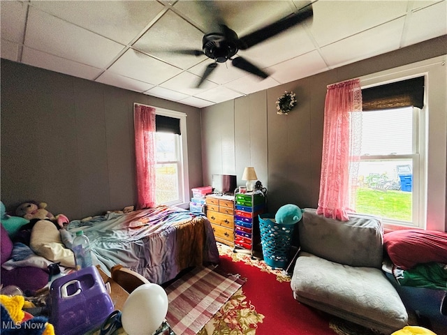 bedroom featuring a drop ceiling and ceiling fan