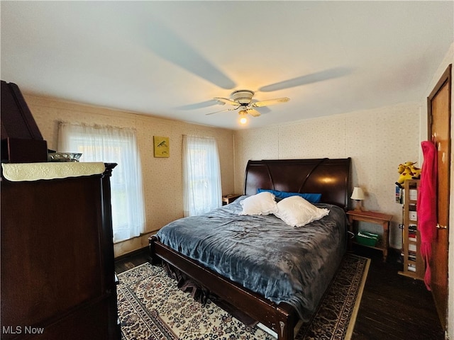 bedroom with ceiling fan and dark wood-type flooring