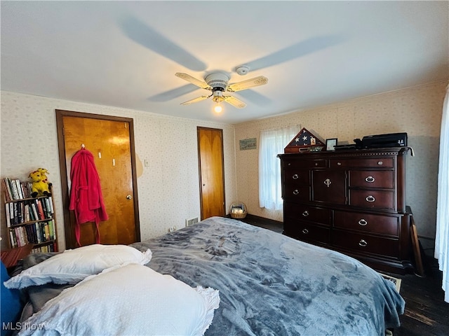 bedroom featuring ceiling fan and dark wood-type flooring