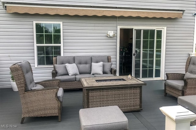 view of patio with a deck and an outdoor living space with a fire pit