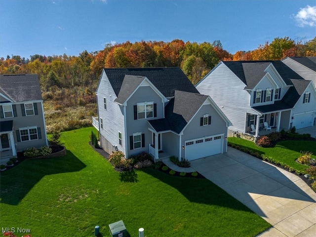 front of property featuring a front lawn and a garage