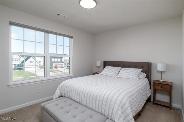 bedroom featuring light carpet