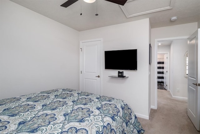 bedroom featuring a closet, ceiling fan, light carpet, and a textured ceiling