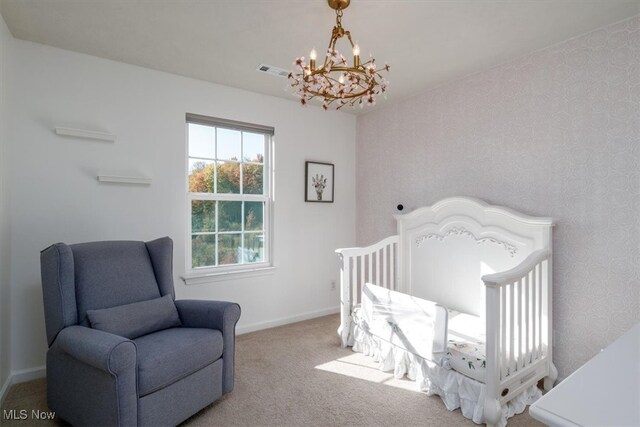 bedroom featuring light carpet and an inviting chandelier