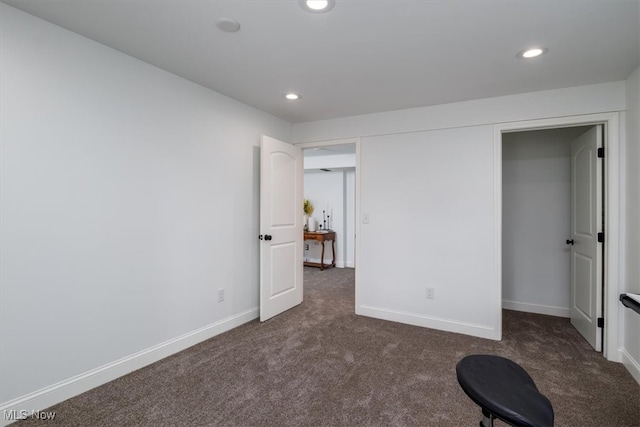 unfurnished bedroom with dark carpet