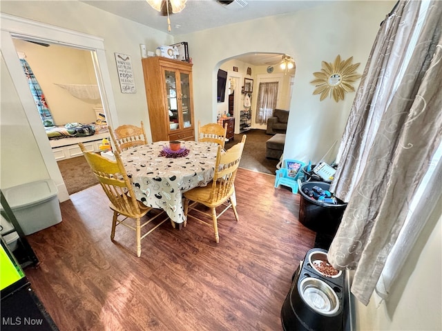 dining room with dark wood-type flooring and ceiling fan