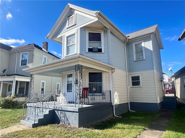 view of front of house with covered porch and a front yard