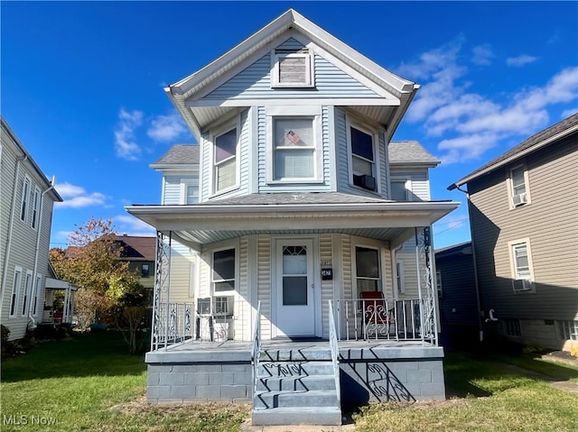 view of front of home with a front yard, cooling unit, and a porch