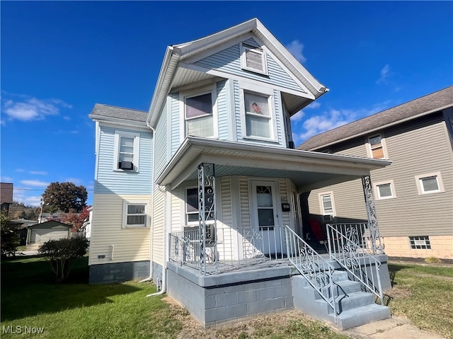 view of front facade with cooling unit, a front lawn, and covered porch