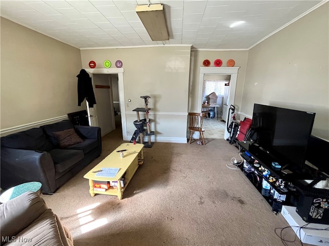 living room with ornamental molding and carpet flooring