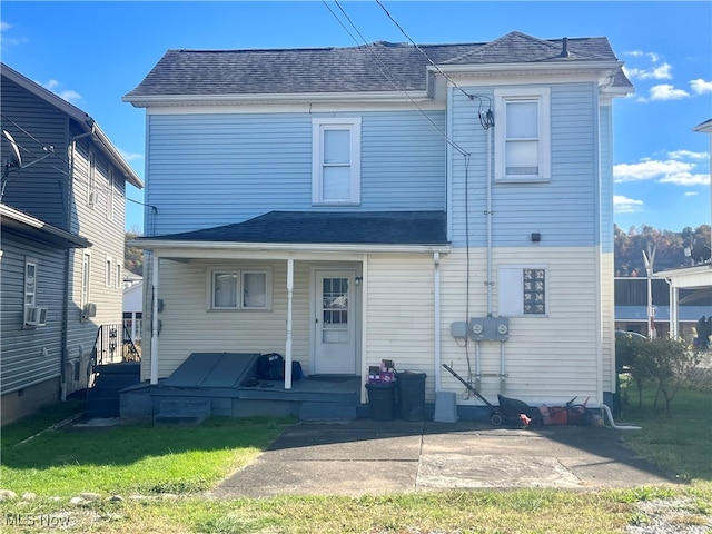 rear view of house with a yard