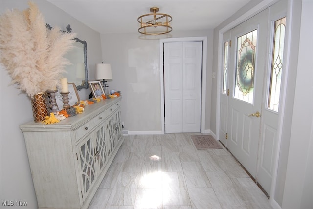 foyer entrance featuring an inviting chandelier