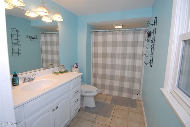 bathroom with tile patterned floors, toilet, a shower with curtain, an inviting chandelier, and vanity