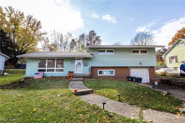 split level home with a garage and a front yard