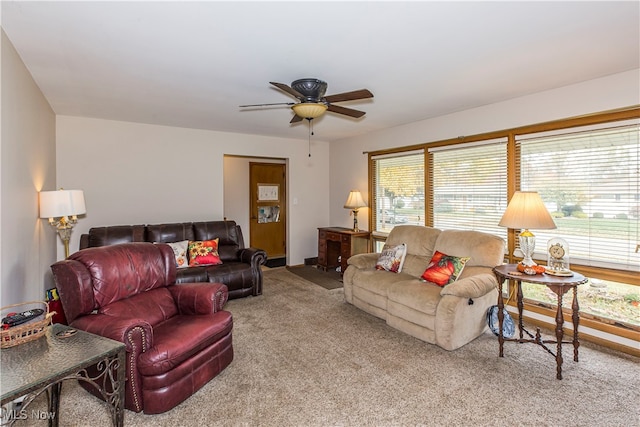 carpeted living room featuring ceiling fan