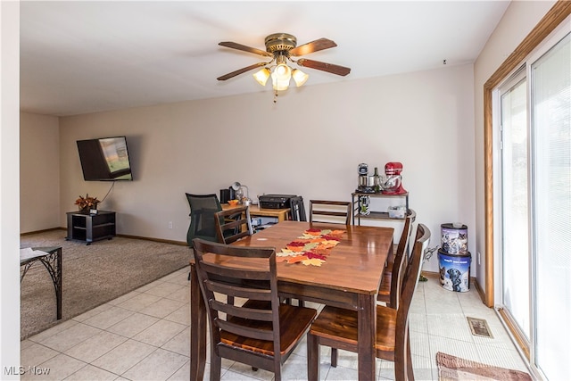 carpeted dining area featuring ceiling fan